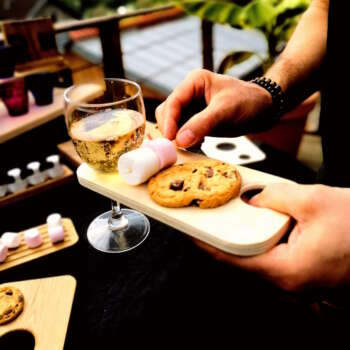 Planche apéritif en bois de contre-plaquée de Peuplier éco-responsable, faite main, avec un design fonctionnel permettant de tenir un verre à pied et des snacks. Accessoire en bois durable, fabriqué artisanalement à partir de matériaux recyclés, incarnant le savoir-faire local et une approche zéro déchet. Idéal pour des événements, avec une éthique de fabrication et un design sur-mesure