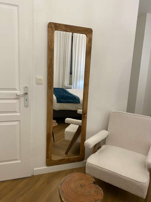 Miroir sur mesure arrondi en chêne massif posé dans une chambre design